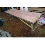 A folding wooden table, 6' long.