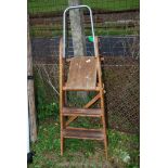 A wooden 3 rung step ladder.