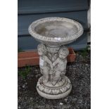 A concrete three cherub bird bath, 23" high.