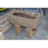 A concrete planter on plinth, 30" long x 21" high x 12" wide.