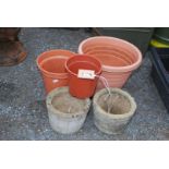 Two concrete planters and various mixed plastic planters.