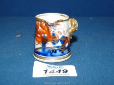 A rare miniature side handled Stoneware Jug painted in the Imari palette and gilded.