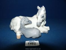 An attractive china figure of a mare and foal laying down, marked Royal Copenhagen, Denmark 4698.