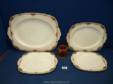 Four graduated meat plates by Grindley in 'Windsor Ivory' pattern and a silver jubilee 1977 mug.