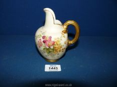 An Edwardian Royal Worcester flatback jug painted finely with flowers and with an ornate heavily