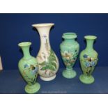 A pair of green glass vases with hand painted cornflowers, butterflies and grain stems,
