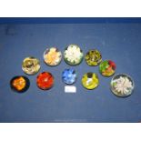 Ten glass floral paperweights, various colours.
