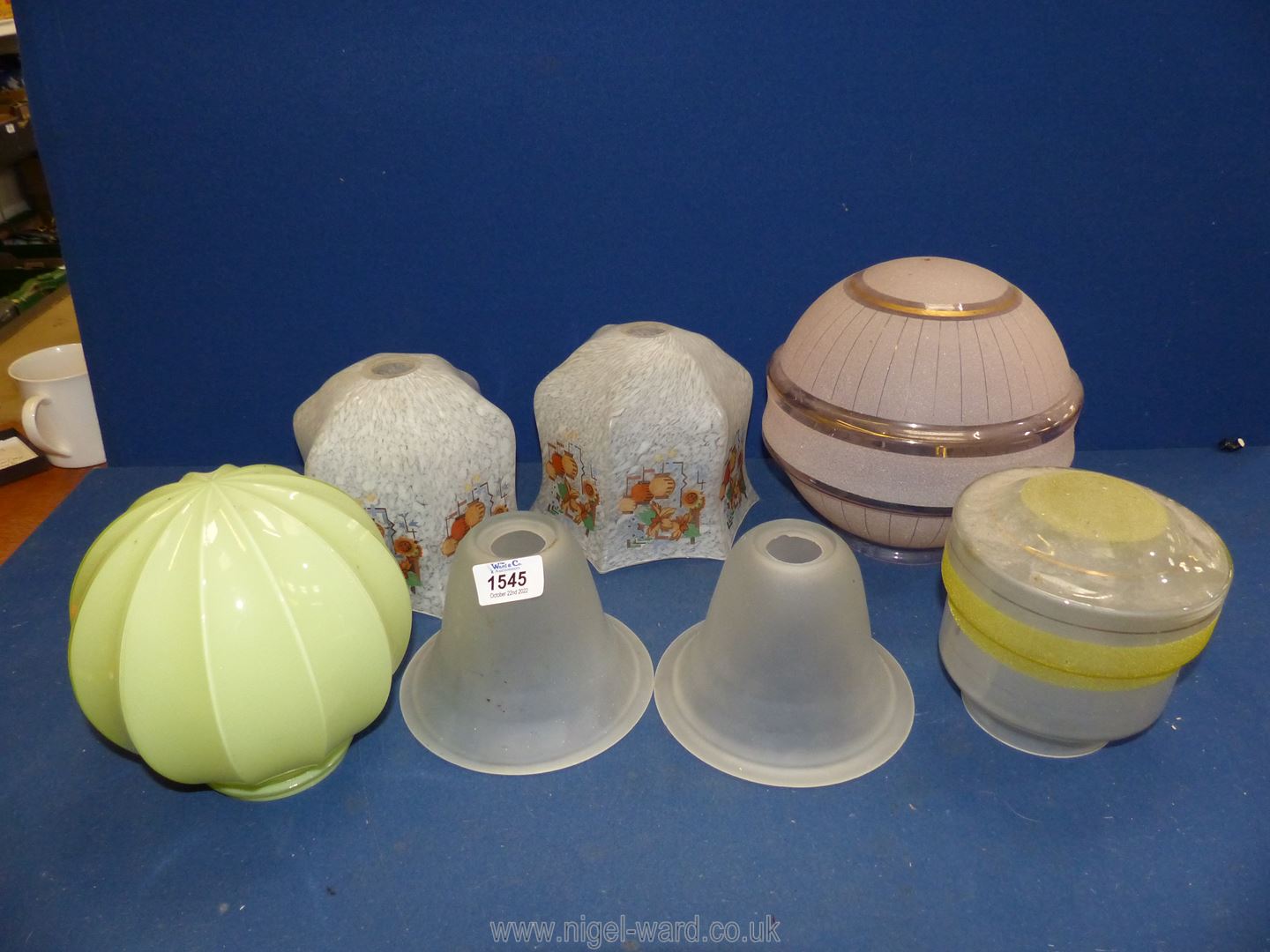 A quantity of coloured glass lampshades including frosted pink, opaque pale green,
