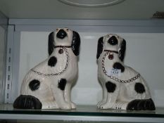 Two Staffordshire style black and white mantle spaniels, some crazing.