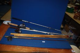 Two vintage split cane fly fishing rods and a collapsible fishing net.