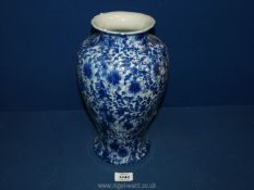 A Victoria ware vase in all over blue floral design, 12" tall.