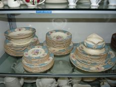 A good quantity of 'Myott' Staffordshire Rose dinner ware, floral pattern with blue lattice rims,