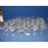 a quantity of various glasses with overlapping circular etching around rims along with various