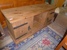 A rustic Pine low Sideboard having heavy iron strap hinges and drop ring handles to the opposing