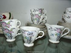 A Windsor bone china part tea service in pink, blue and grey floral design with gold rims.