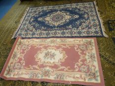 A navy blue rug 71" x 41" and a pink rug with floral pattern 59" x 31 1/2".
