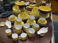 A quantity of Balinese dinner and Teaware with wild animals painted on a vivid yellow ground and
