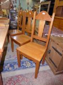 A matching set of eight light Oak Dining Chairs having solid seats,