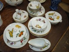 A quantity of Royal Worcester 'Evesham' dinnerware with gilt rims including two lidded vegetable