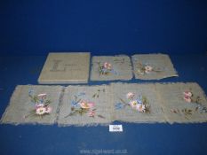 A Liberty of London boxed set of napkins, hand painted with flowers.
