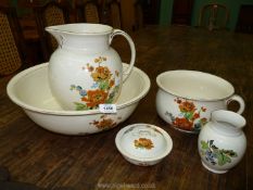 A Lawleys wash stand set in cream with orange and blue floral decoration, soap dish- cracked,