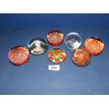 Seven glass paperweights, mostly Millefleur style etc.