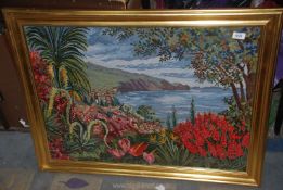 A tapestry of a cliff scene with shrubbery and flowers surrounding 27½" x 36".