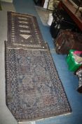 Two small blue Rugs, bordered, patterned and fringed, some wear, 58'' x 30'' and 37'' x 35''.