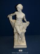 A large Art Deco style plaster figure of a young lady leaning on a boat R.No 6944 on back, 19" tall.