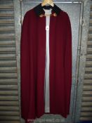 A fine Burgundy woollen cape with grey silk lining,