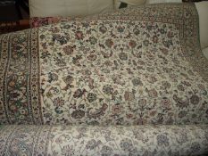 A Kasbah cream/green floral pattern rug with border pattern 79" x 56".