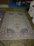 A light blue/brown rug with border pattern 92 1/2" x 63".