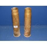 Two brass shell cases.