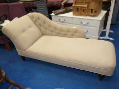 A cream upholstered Chaise Longue on turned feet.