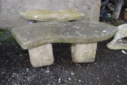 A shaped concrete bench, 4' wide x 18" high.