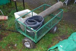 A wheeled Garden trolley, mop bucket and small roll of felt.