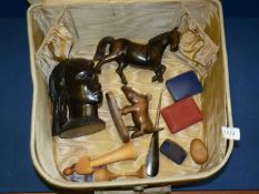 A Vanity case containing ebony handled buttonhook, wooden carved figures including horse,