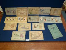 A box of 'Wills' and 'Players' cigarette card albums (12 complete).