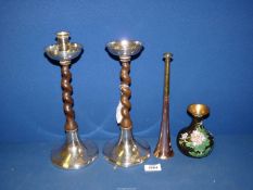 A pair of early 20th century Arts & Crafts candlesticks with hand beaten bases in white metal