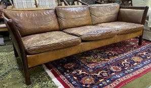 A Stouby Danish design three seater Settee of some style having dark hardwood show frame and