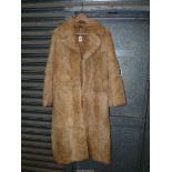 A full length rabbit fur Coat, gold coloured lining, size 14.