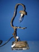 An Art Nouveau style table lamp with iron branch lamp holder and marble base, 19'' high overall.