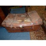 A large leather cased, wicker Travel Trunk, linen lined, having leather straps and labels,