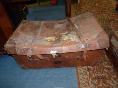A large leather cased, wicker Travel Trunk, linen lined, having leather straps and labels,