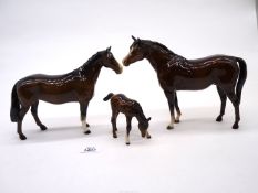 Two Beswick brown horses with original sticker, plus a Beswick brown foal.