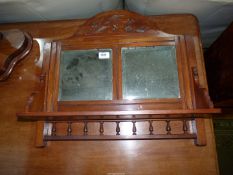 A Mahogany Wall Shelf with bevelled edge mirror back, and turned detail to undershelf,