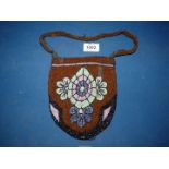 A 1920's beaded purse, brown with turquoise flowers, (some damage).