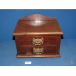A small two drawer Cabinet with brass handles (possibly from a dressing table),