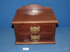 A small two drawer Cabinet with brass handles (possibly from a dressing table),