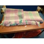 A pair of green, cream and pink Woolen Blankets with fringing.